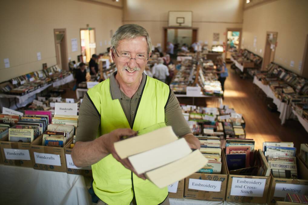 Getting a bargain: Volunteer Rod Devenish showing off some of the thousands of paperbacks on offer at the UnitingCare Book Fair held at St Andrew's Hall at the weekend. Picture: Luka Kauzlaric