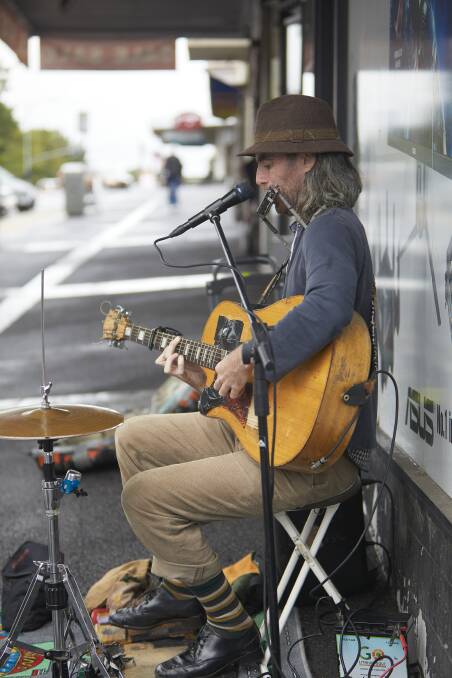 Entertaining: Tim Scanlon tries to draw a crowd with his eclectic mix of Celtic and reggae music along Sturt Street on Saturday. Picture: Luka Kauzlaric 