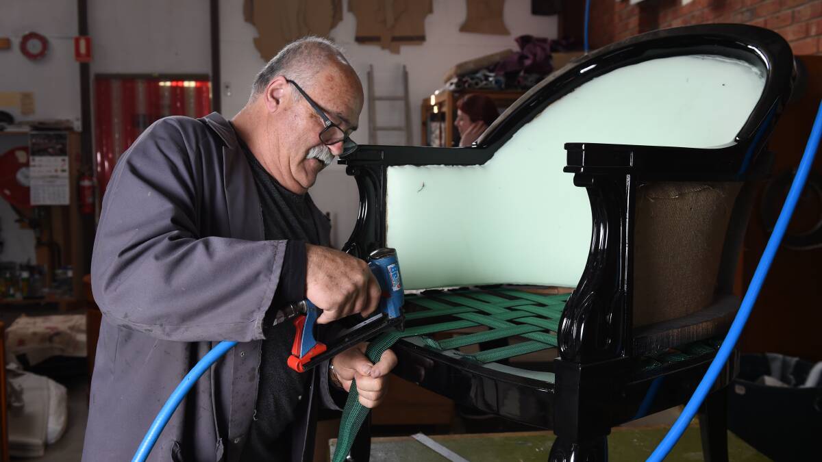 Chris Christofi at work in the Buttoning Upholstery warehouse on Latrobe Street. Picture: Kate Healy 