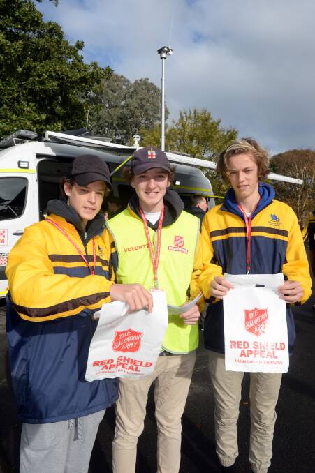 Taking to the street: Ballarat Grammar year 10 students Jacob Vagg, Parker Vize and Aedan Roberts prepare for the Salvos Red Shield Appeal.  Picture: Kate Healy. 