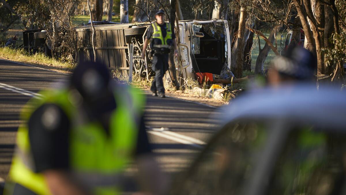 Police inspect the wreckage of the bus which rolled near Avoca on Saturday afternoon. Picture: Luka Kauzlaric 