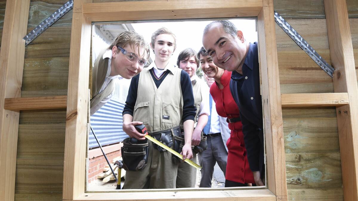 Picking up skills: Phoenix P-12 year 12 students Jay, Brendan and Josh show off some of their handiwork to Buninyong candidate Michaela Settle and Education Minister James Merlino. Picture: Lachlan Bence 