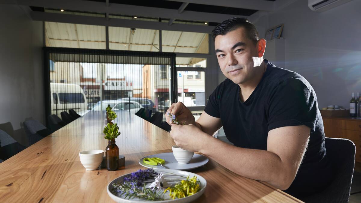 New premises: Derek Boath takes a seat at the custom made table at Underbar in Doveton Street North which seats just 12 customers.  Picture: Luka Kauzlaric.    