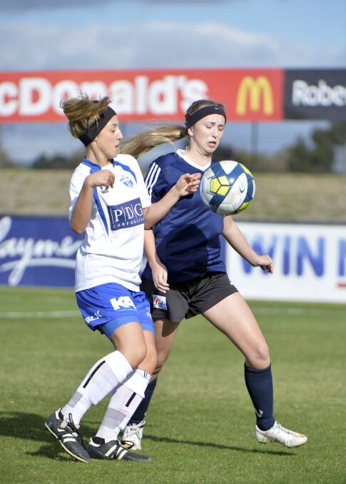 Tight tussle: Alanah Giuliano from South Melbourne and Erin Plucke from the Eureka Strikers compete for the ball in their round two encounter at Morshead Park on Sunday.  Picture: Dylan Burns.