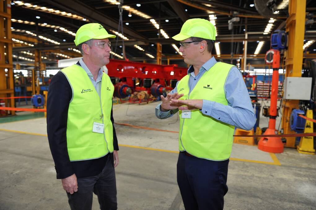 Local jobs: Industry and Employment Minister Wade Noonan with MaxiTRANS group general manager Anthony Roder.       