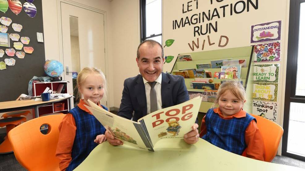 Education Minister James Merlino with Siena Catholic Primary School prep students Eloise Hertnan and Amelia Loader earlier this yearl. Picture: Jeremy Bannister
