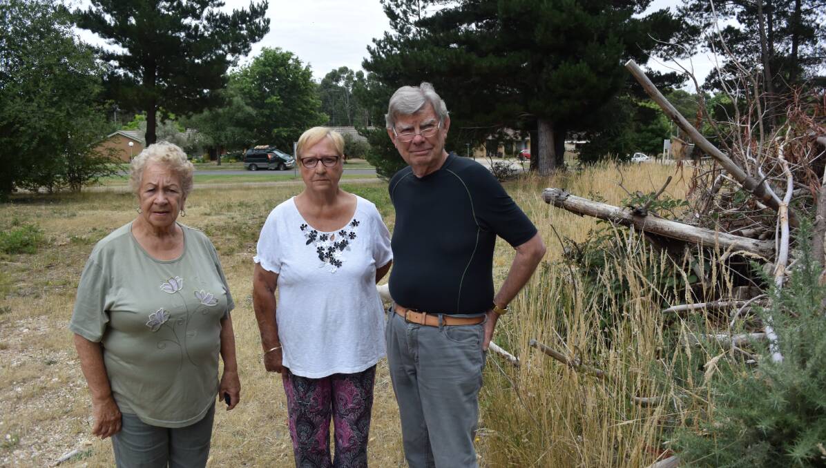 Concerned: Creswick residents Maureen Tait, Maureen Goppick and Russell Castley inspect the long grass near their housing complex. 