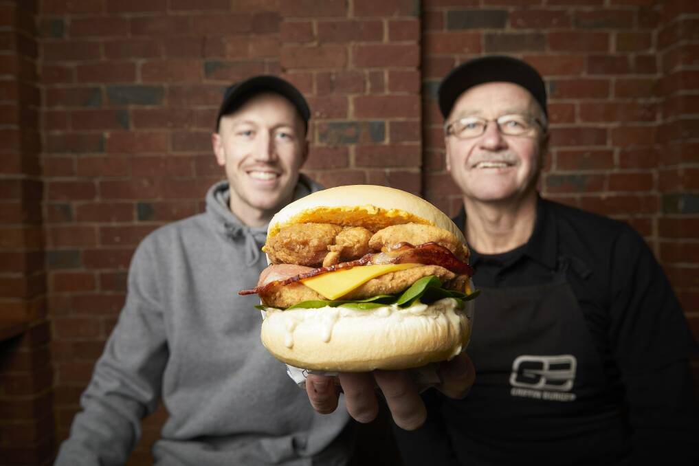 Ballarat's favourite burger: Sam and Peter Griffin from Griffin Burger with one of their creations.  The Armstrong Street store was named Ballarat's favourite in The Courier's poll. Picture: Luka Kauzlaric. 