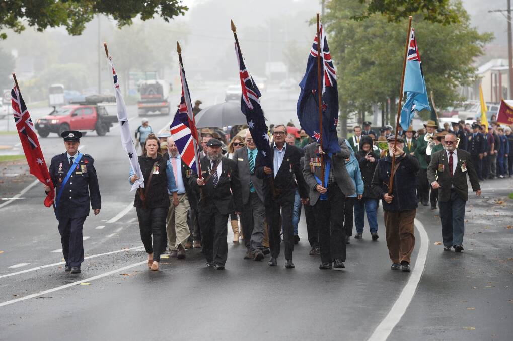 Marching on: A procession of more than 100 people made their way down Albert Street in Creswick on Tuesday morning for Anzac Day.  Picture: Kate Healy.  