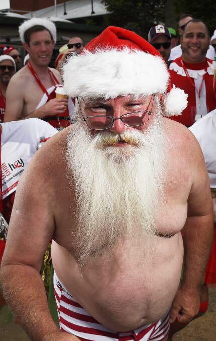 Christmas attire: Richard Egan forgot to bring his Stanta suit to the annual Sexy Santa Pub Crawl in Daylesford on Sunday.  Picture: Luka Kauzlaric. 