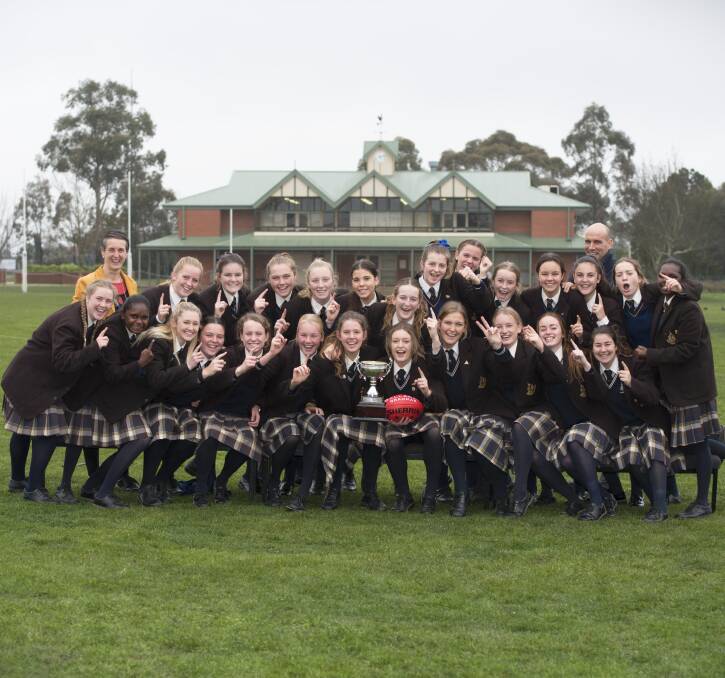 Three on the trot: Ballarat Grammar's senior girls football side celebrate after defeating Loreto College in the BAS final. 