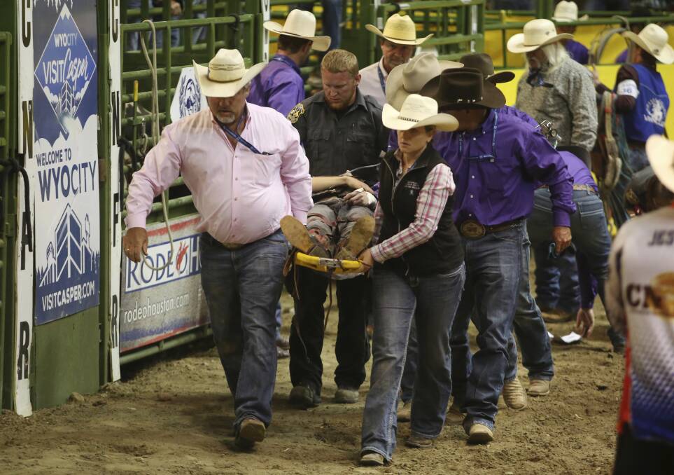 CRITICAL: Coaches and emergency crews carry NSW bull rider Bradie Gray from the arena during the College National Finals Rodeo in Casper, Wyoming. Picture: Alan Rogers/The Casper Star-Tribune