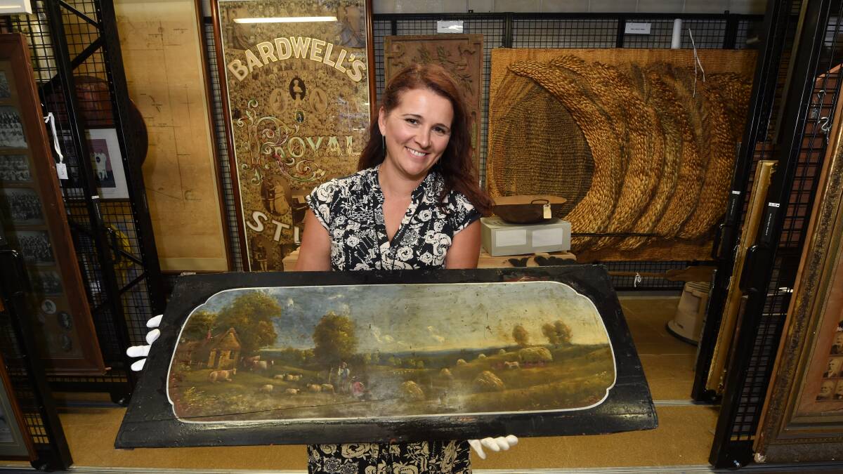Handover: Elizabeth Marsden (Gold Museum manager of collections) with the panel from the 1850s Leviathan coach. Picture: Jeremy Bannister.