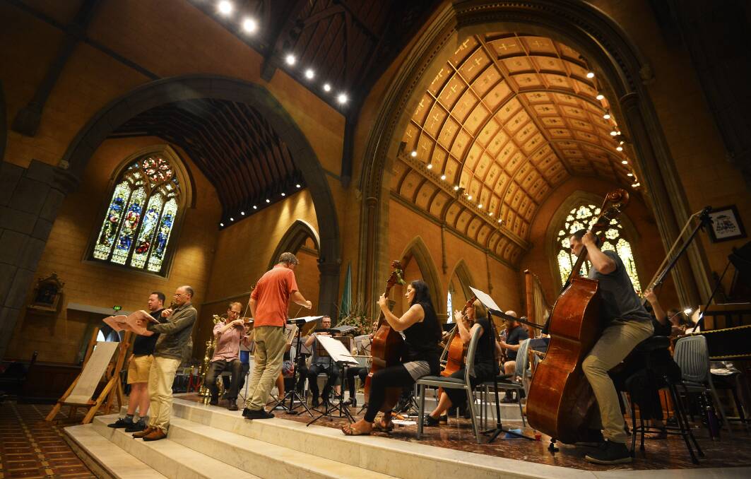 A glorious setting: Gary Ekkel directs the Festival Orchestra and Choir of Newman College in the rehearsal of the music of Rameau. Picture: Dylan Burns.