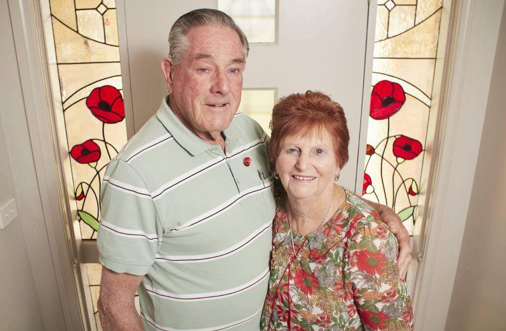 Remembrance: Mervyn and Maree Sherlock with the specially-made Flanders poppies windows in their home. Picture: Luka Kauzlaric.