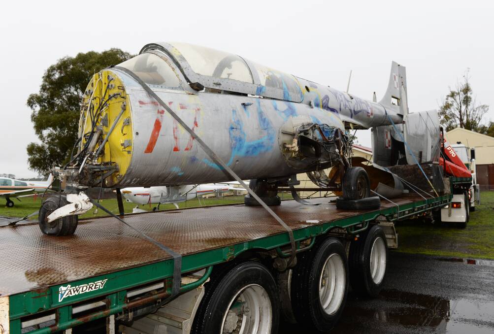 Flagged and tagged: The jet carries a Polish insignia and some latter-day graffiti - to be removed. Photo: Kate Healy.
