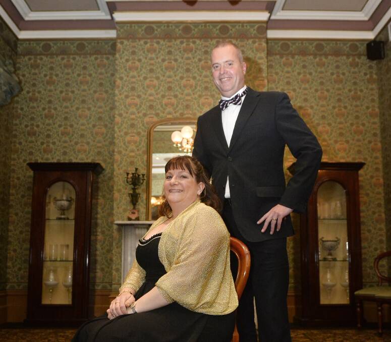 A touch of gold: Janice Shelmerdine (deputy chair) & Brett Macdonald (business manager) of the Royal South Street Society at the 125th anniversary fundraiser on Saturday night. Photo: Dylan Burns.