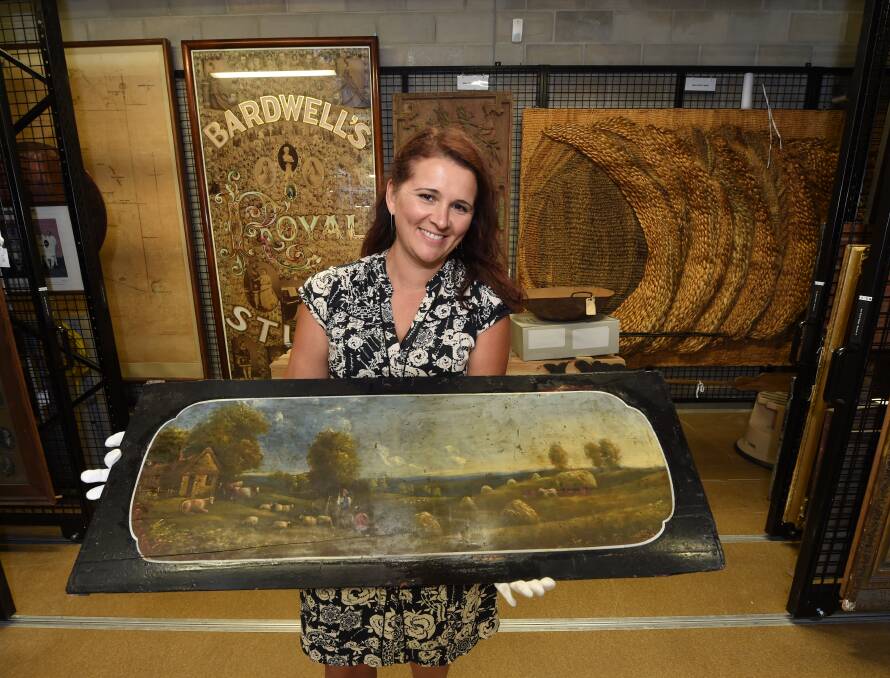 Handover: Elizabeth Marsden (Gold Museum manager of collections) with the panel from the 1850s Leviathan coach. Picture: Jeremy Bannister.