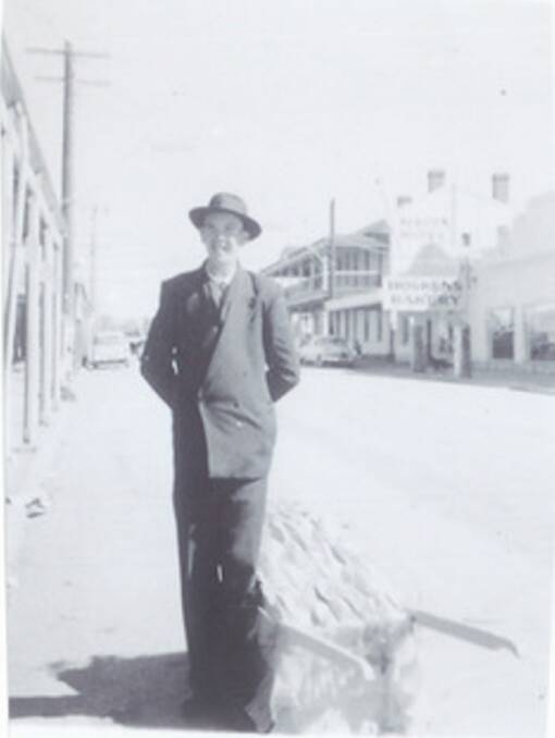 In the beginning: A young Wal Richards with his barrow in double-breasted suit and hat at the top end of High Street, Maryborough, sometime in the 1950s. Picture: photographer unknown.