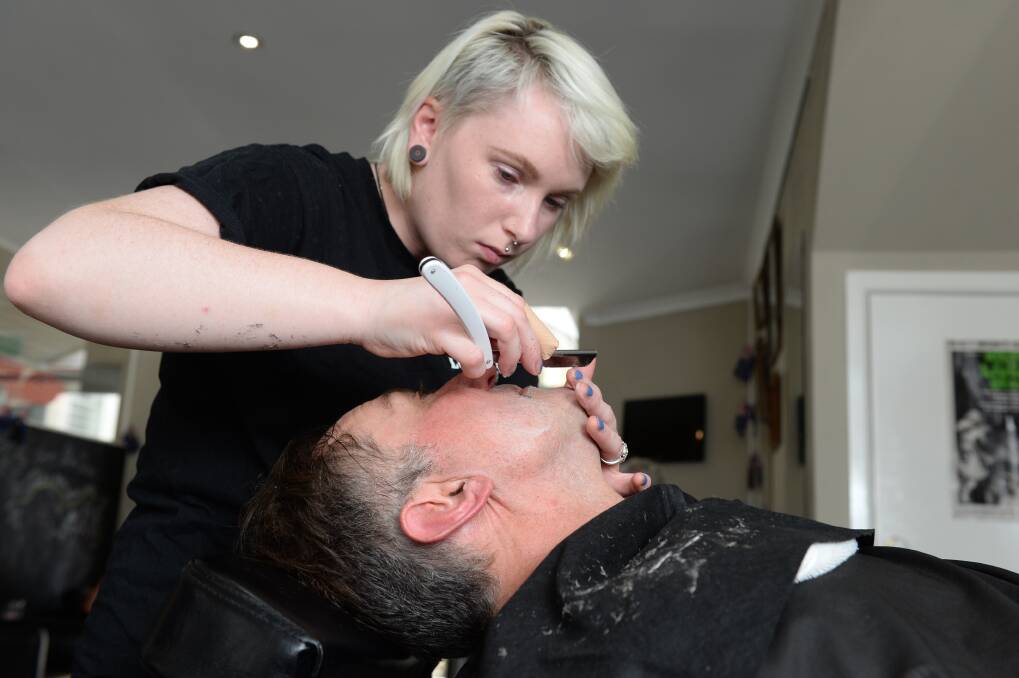 The straight shave: Rachel Lawrey finishes shaving Caleb Cluff. Photo: Kate Healy