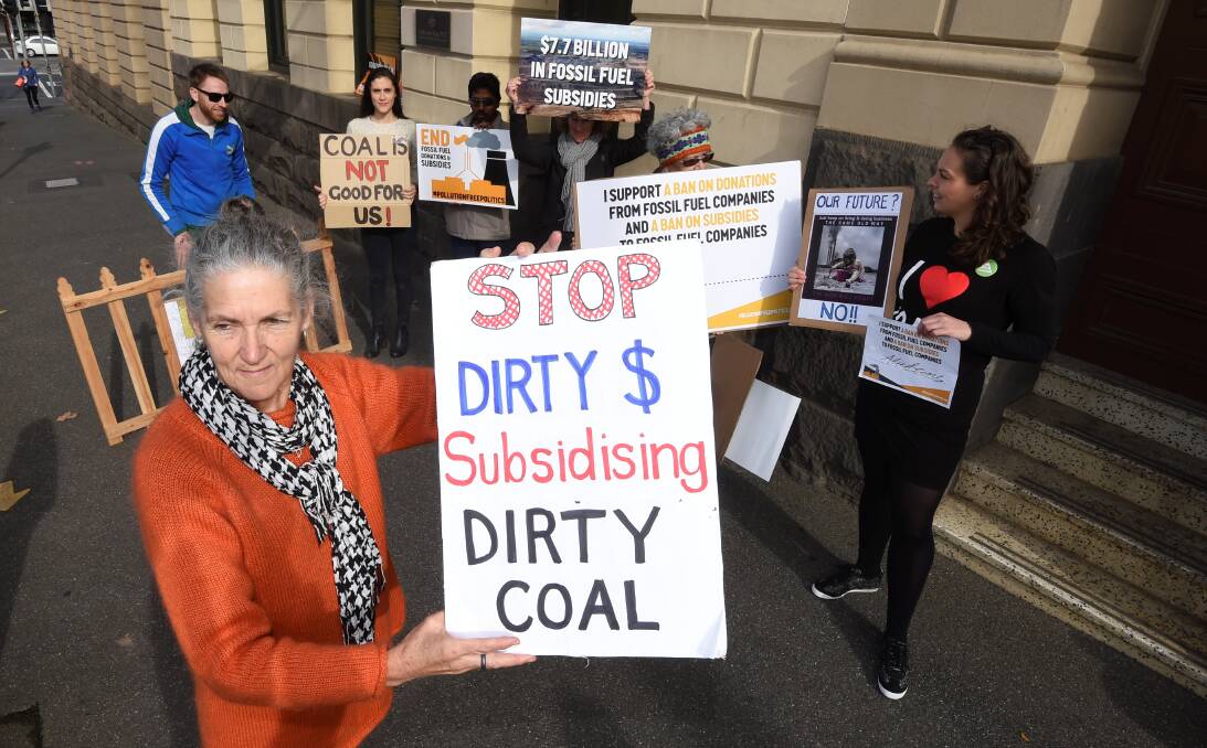 Get off the fence: Member of the Ballarat Climate Action Group Jane Marriott at the front of the protest outside Catherine King's office. Photo: Lachlan Bence.