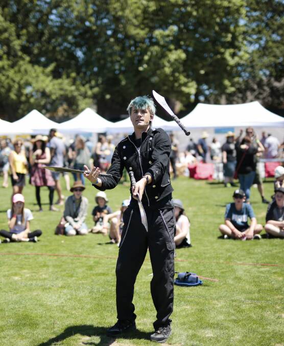 Thrills and escapes: Sword juggler and escapologist Malachi Frost kept the crowds, young and old, entertained with his show. Picture: Luka Kauzlaric.