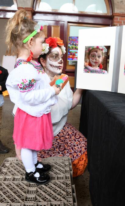 Día de los Muertos: Sally Myers, 3, and Catherine Toro, a Chilean member of Ballarat Spanish-speaking network, reflect on the celebrations involved in the Day of the Dead at the Ballarat Mining Exchange. Picture: Lachlan Bence.