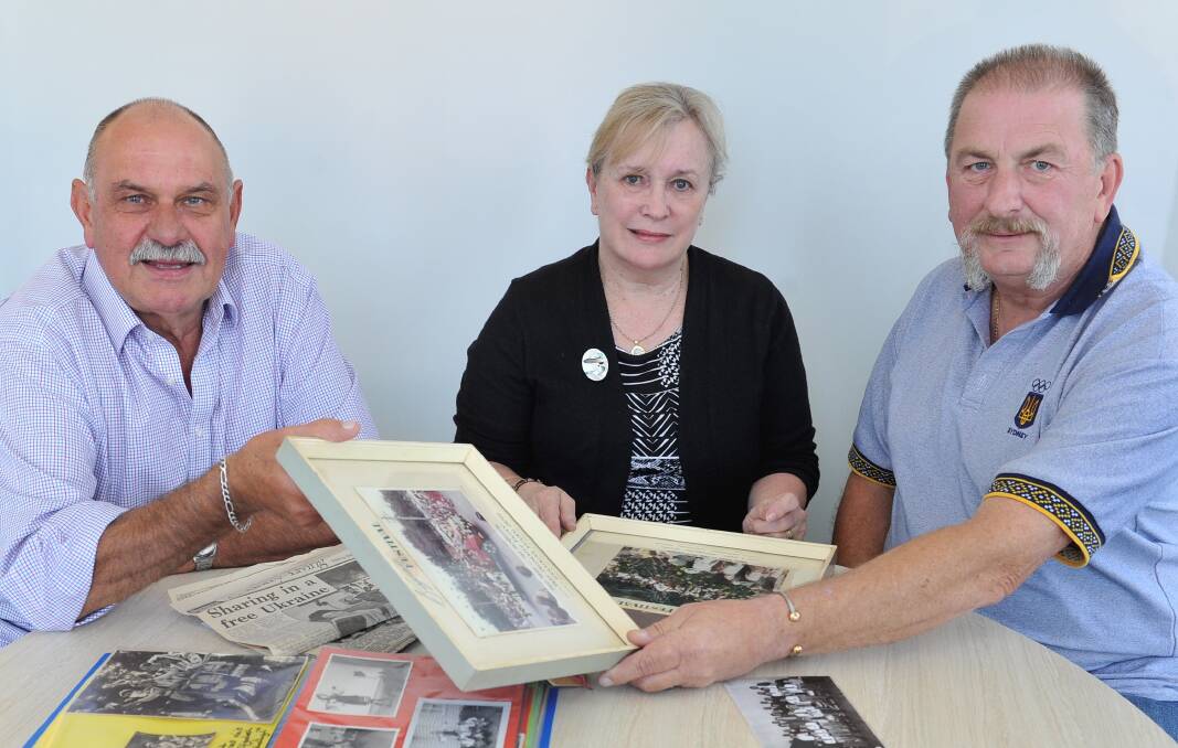 Stephan Salo, Vera Zylan and Roman Popowycz holding images of their Ukrainian cultural childhood in Ballarat. Picture: Lachlan Bence.