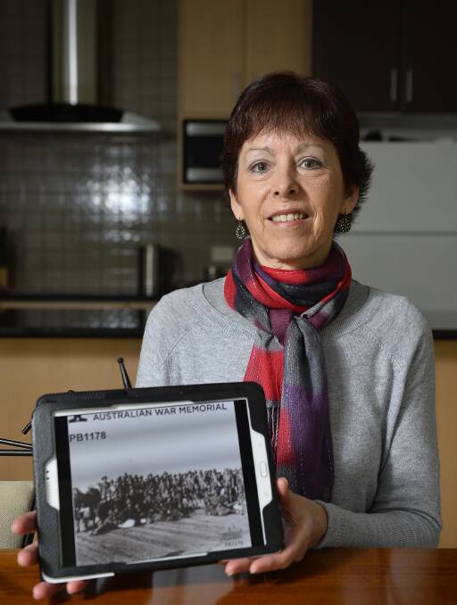 Not honoured: Gail Buchanan with a picture of her great-uncle Thomas Mulligan on the docks before embarking for the Great War in 1916. He was 18. Photo: Luka Kauzlaric.