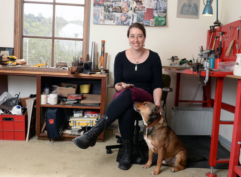 A family of tinkerers: Rachel Grose and her faithful assistant Navarre in her Ballarat studio. Grose makes jewellery here from many elements, including recycled rings. Picture: Kate Healy.