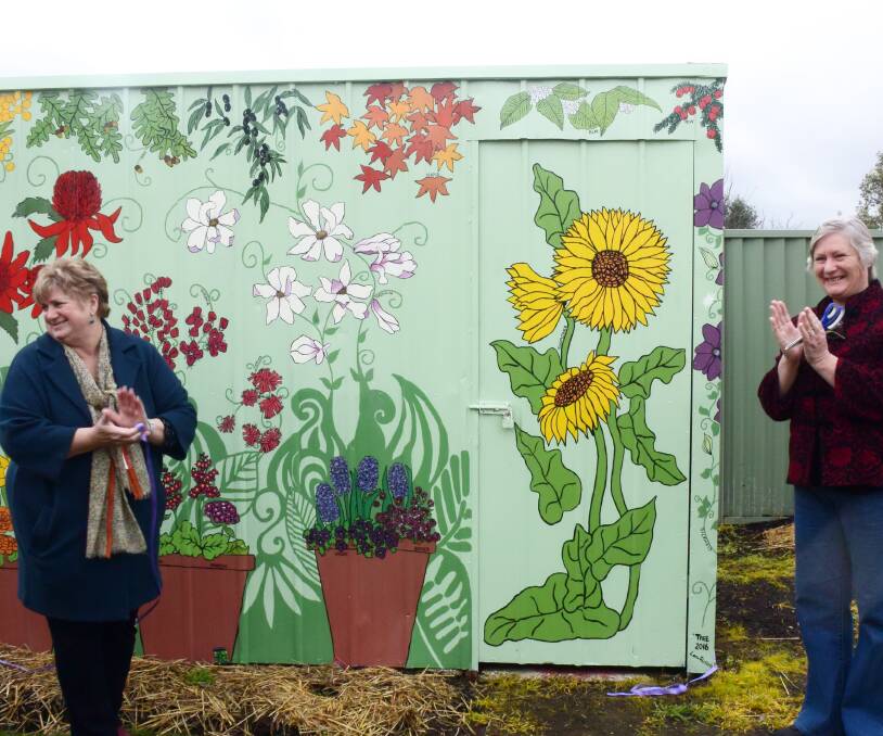 Flower Street mural: Wendouree Neighbourhood Centre community officer Kate Owen and artist Anna King with the shed mural. Photo: Caleb Cluff.