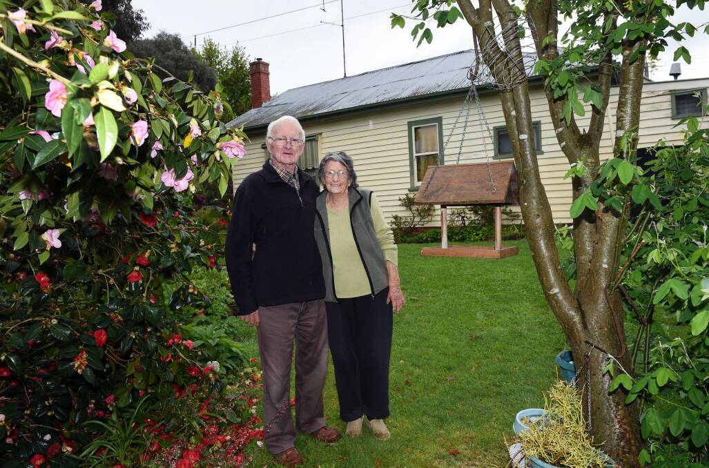 One hundred roses: Charlie and Barbara Saunders in their garden at the rear of their home in Canadian. Picture: Kate Healy.