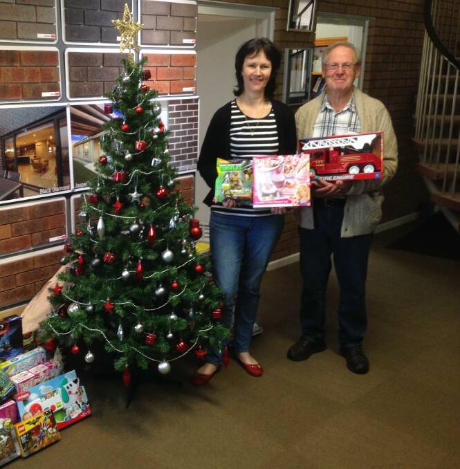 CHRISTMAS SPIRIT: Charity representatives Pauline Prebble and Frank Stuart are happy accepting some of the toys which will make a big difference in disadvantaged children's lives. Picture: Connor Prebble