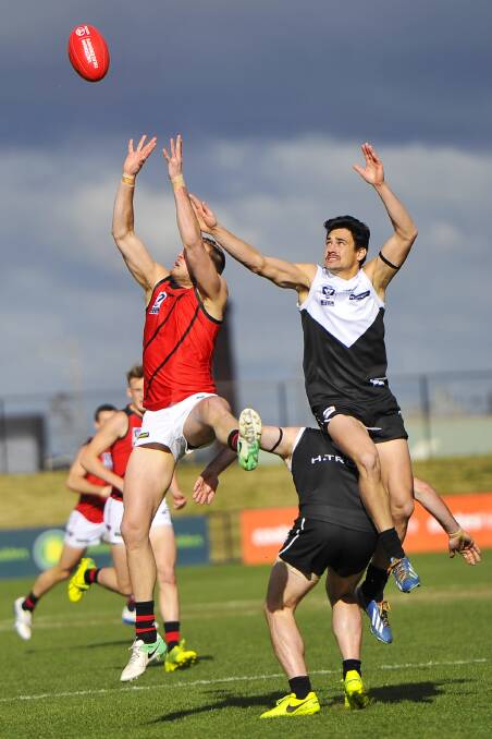 LAUNCH: North Ballarat's James Keeble flies for the ball as Essendon's James Ferry goes back with the flight. Pictures: Dylan Burns.