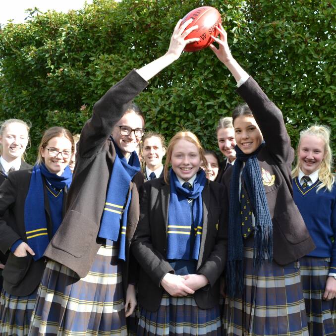 BIG STAGE: Ballarat Grammar vice-captains Faith McKenzie and Nicola Penny hold the ball aloft with skipper Amy Jackson and fellow teammates. Picture: Supplied.