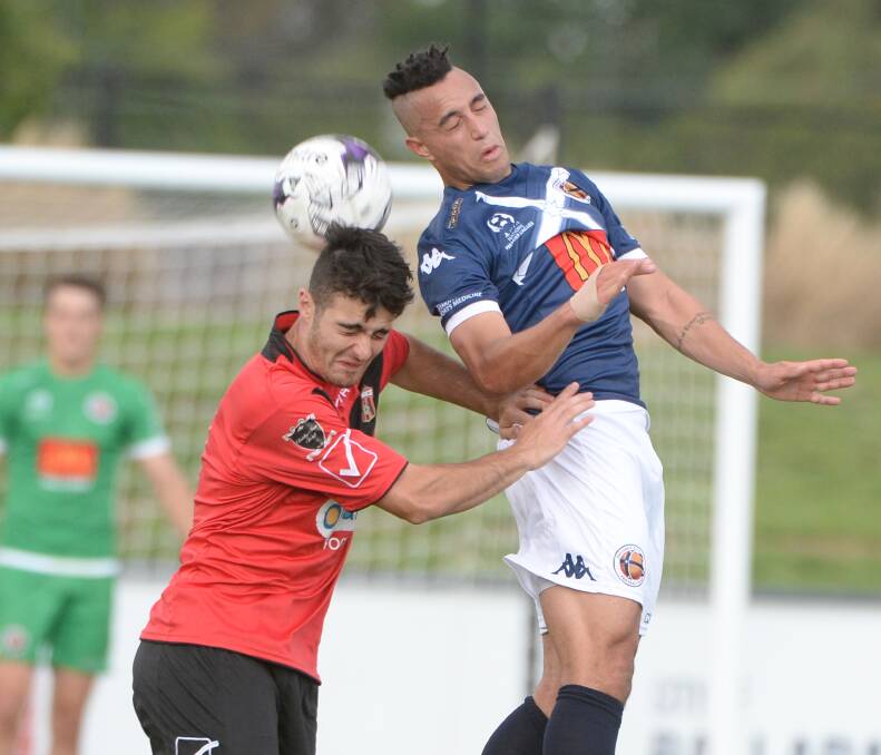 AERIAL BATTLE: Ballarat City's Charles King tussles for position with his Whittlesea opponent Thomas Barforosh in Saturday night's clash.