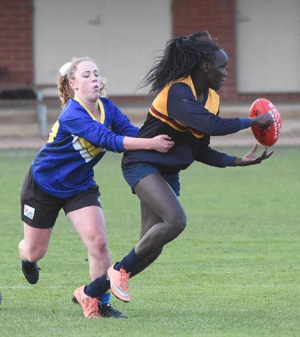 TACKLE: Ballarat Grammar's Nykoat Wuol comes under Claire Demuth (Loreto College) pressure as Grammar posted a 25-point victory.