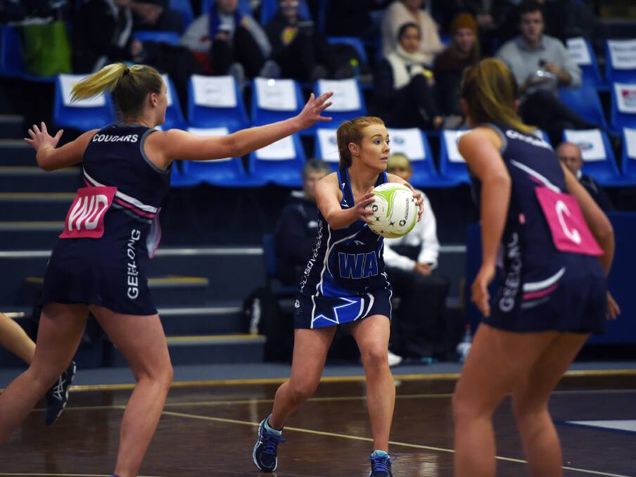Sovereign Ash Ryan assesses her options under the pressure of the Geelong midcourt in yesterday's round 12 clash.