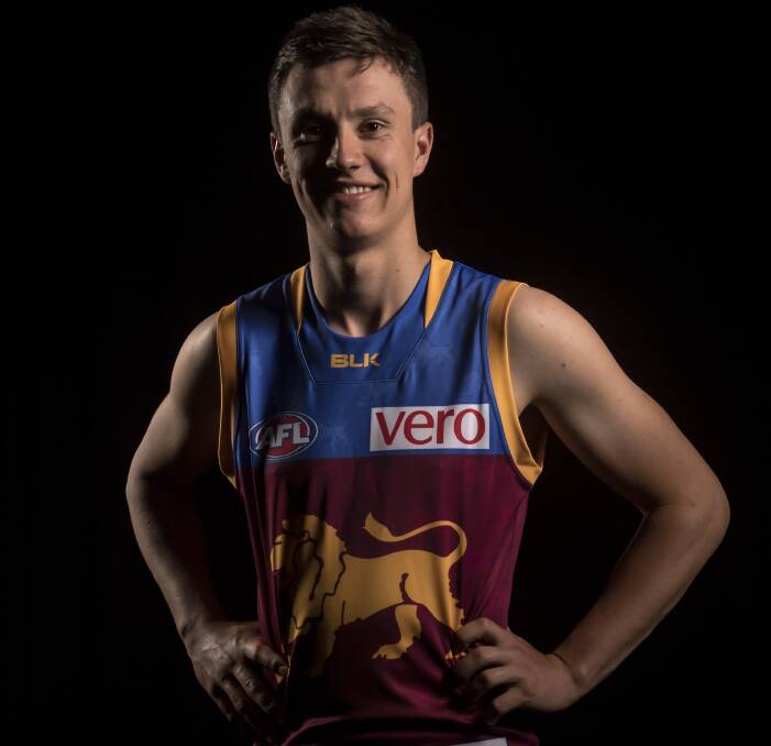 NEW COLOURS: Hugh McCluggage tries on his Brisbane Lions jumper on Friday night. The highly-touted youngster was one of three Rebels to be drafted by the Lions. Picture: Getty Images.