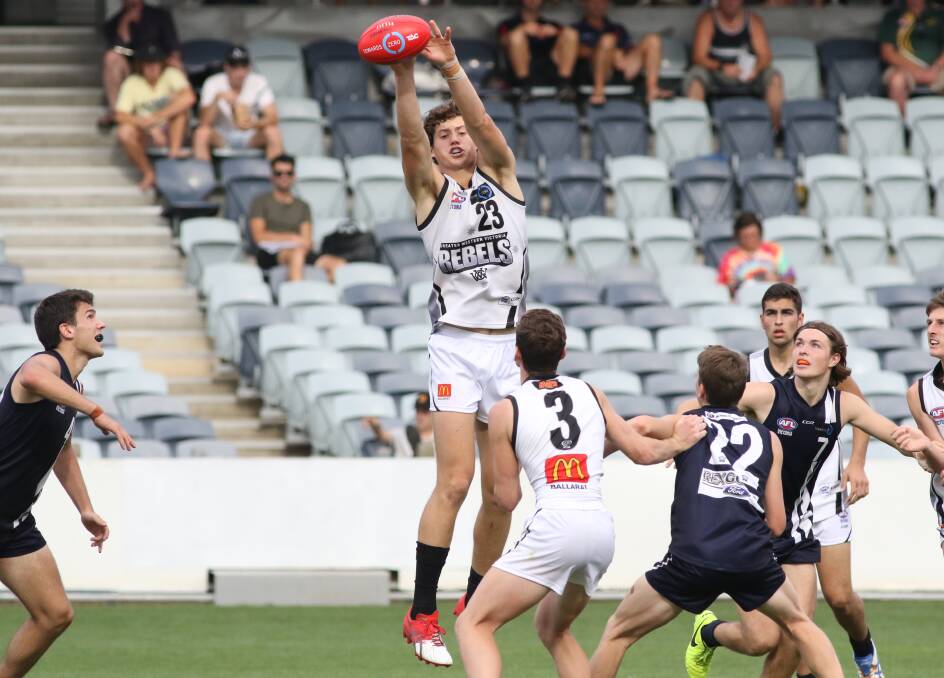 HIT-OUT: Rebels' ruckman Lloyd Meek palms the ball down to Scott Carlin in its round one TAC Cup clash with the Geelong Falcons. Picture: On Deck Media.