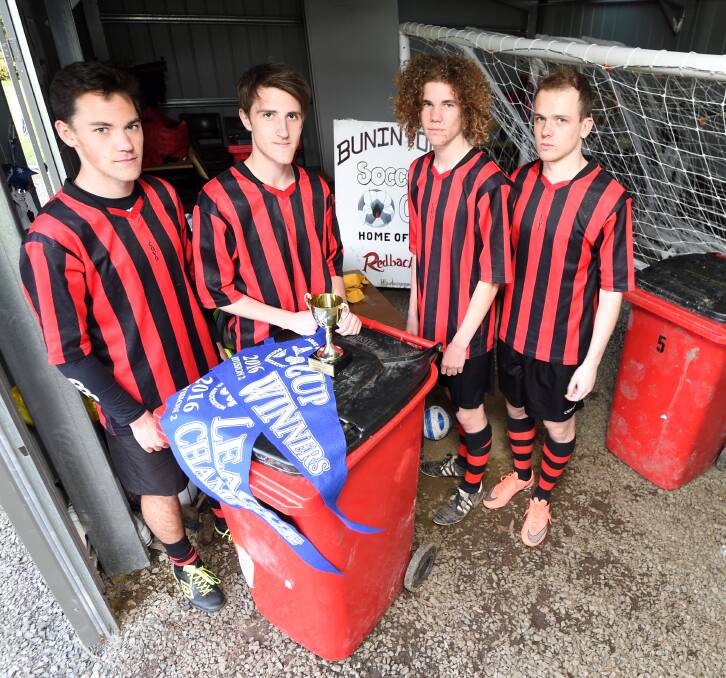 TIGHT FIT: Raphael Mroczkowski, Ethan Watts, Matthew Snibson and Will Gibson show off their premiership and poor facilities. Picture: Lachlan Bence