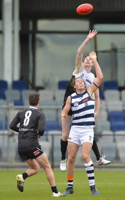 LEAP: Young Rooster Nick Hausler flies over Geelong's Wylie Buzza in Sunday's 49-point loss at Eureka Stadium. Picture: Dylan Burns