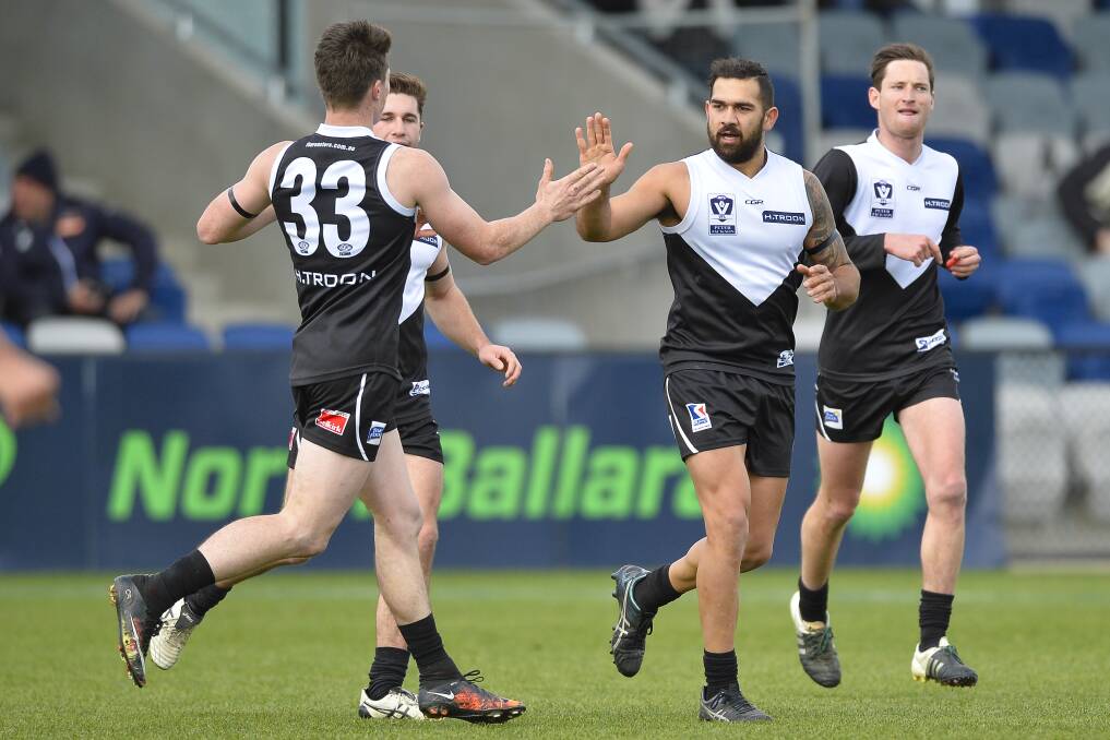 GOT IT: Jacob Cooke-Harrison and Matt Johnston celebrate a North Ballarat goal on Sunday. However, the Bombers came away with a 54-point win.