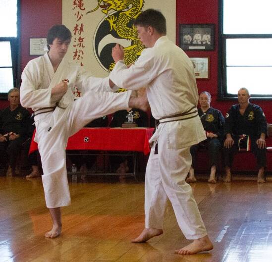 NEW RANKS: Ballarat Karate Club members Matt Anderson and Ben O’Meara sparring in front of their peers. Their hard work has been rewarded with junior black belts.