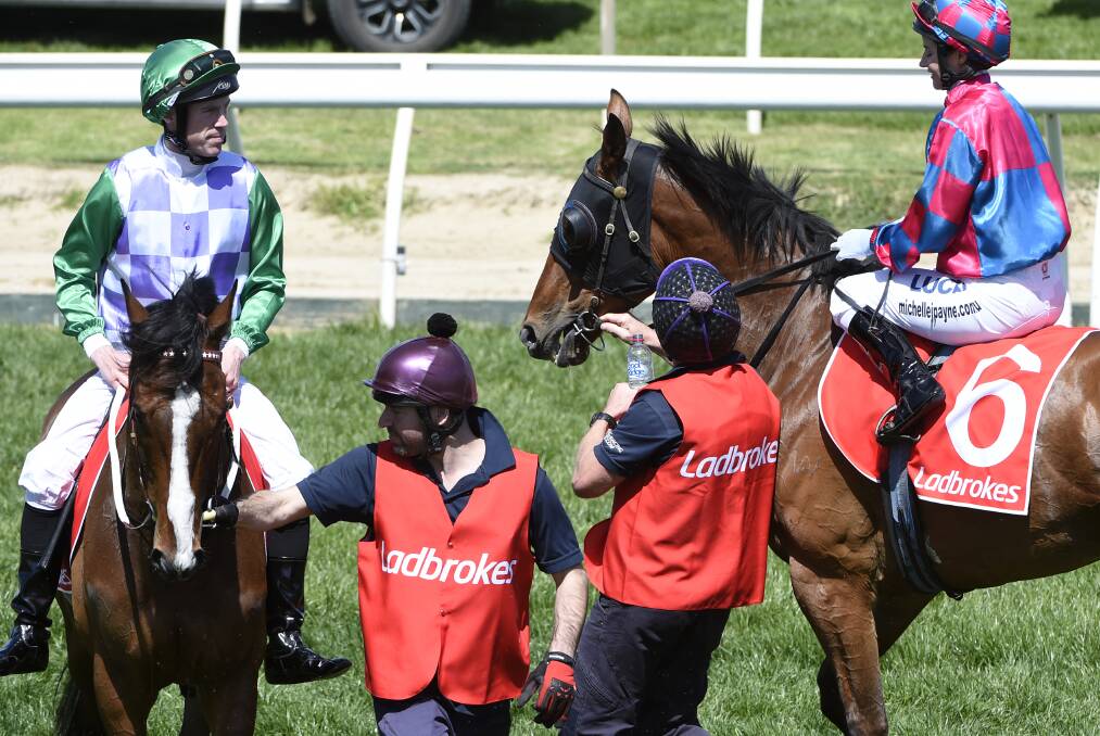 FRIENDS AND FOES: Michelle Payne, right aboard Dandy Gent, looks on while John Allen sits on Prince of Penzance before Saturday's Herbert Power Stakes. Picture: Getty Images.