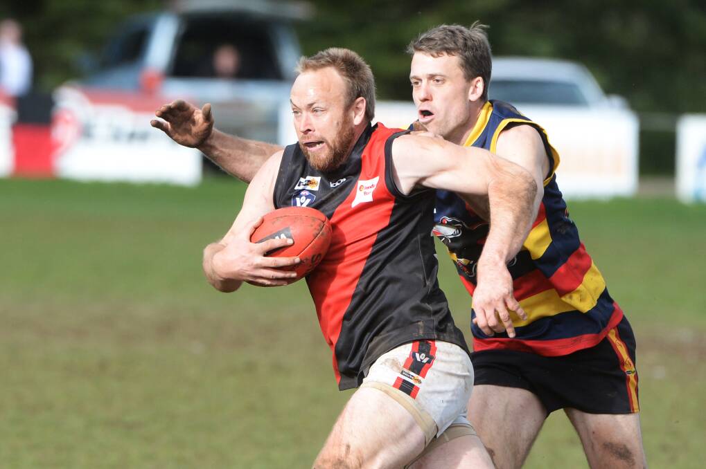GOOD EFFORT: Defender Chris Wills, who is pictured under pressure from Beaufort's Chris Drew, had a good game for Buninyong on Saturday.