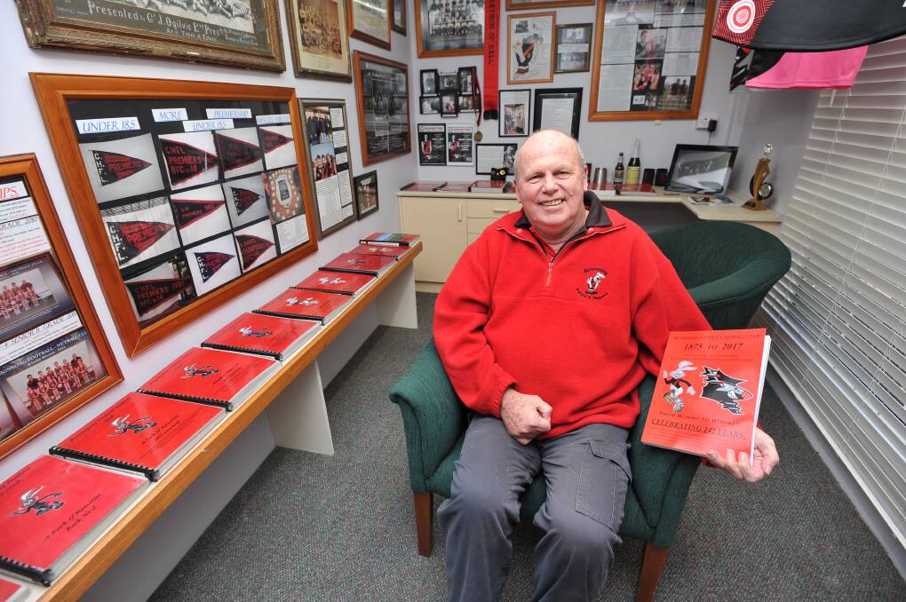 FINISHED PRODUCT: Stan Hunter shows off his history book in a room at his house dedicated to the Buninyong Football Netball Club. Picture: Lachlan Bence.