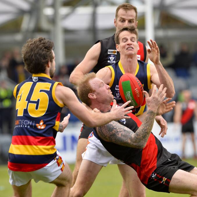 GREAT GRAB: Buninyong veteran Mark Phelps takes an important mark during the reserves grand final triumph over Beaufort. Pictures: Dylan Burns and Lachlan Bence.