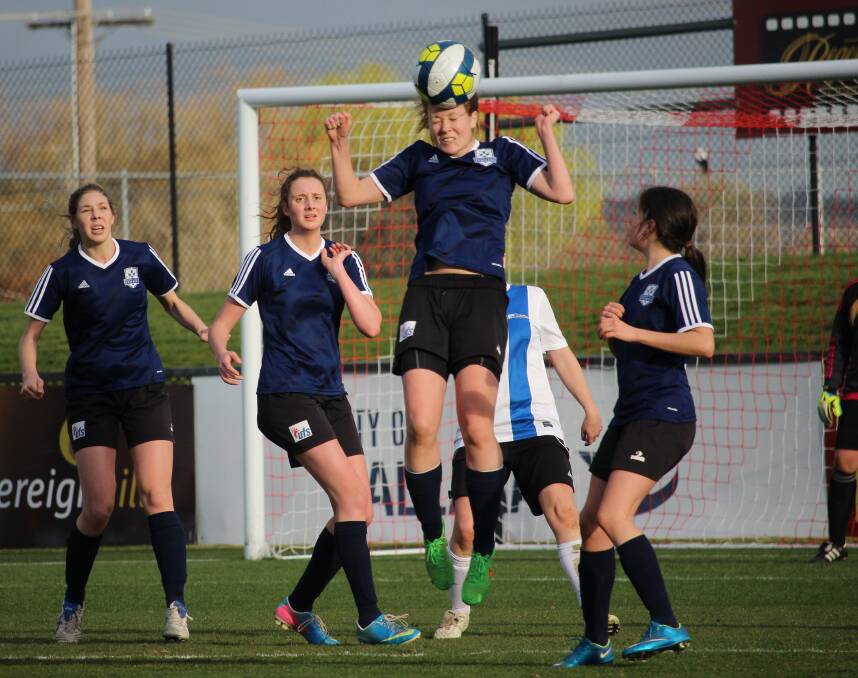 HEADER: Alyson Pym clears the ball out of defence during the Strikers' 3-1 win over University of Melbourne on Sunday. Picture: Bernie Curtain.