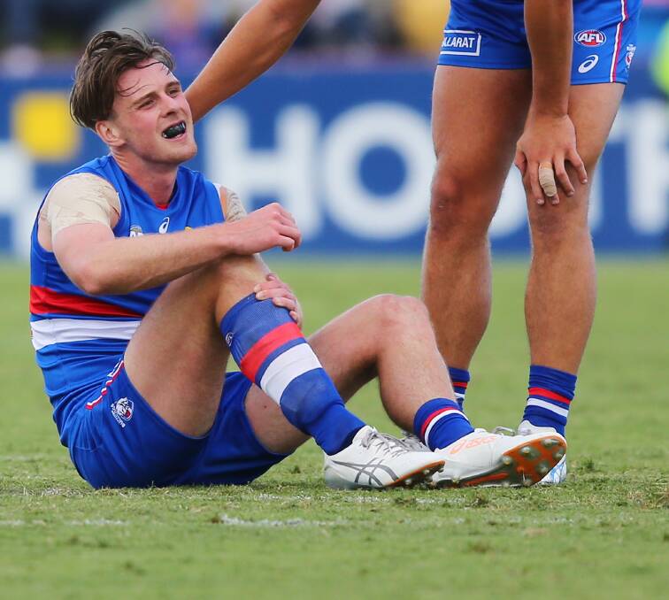 SORE: Jordan Roughead sits on the ground after hurting his knee on Saturday. Picture: Getty Images.